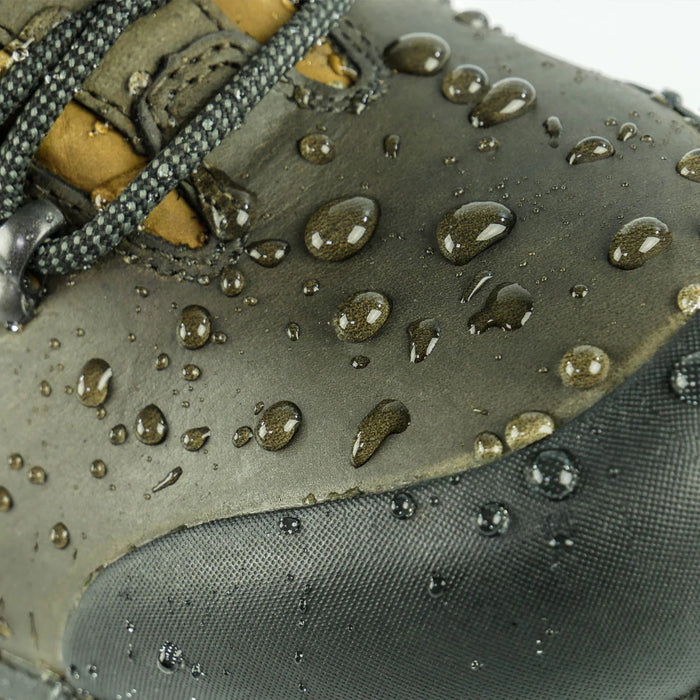 Close-up of a gray shoe with water droplets, emphasizing waterproof material.